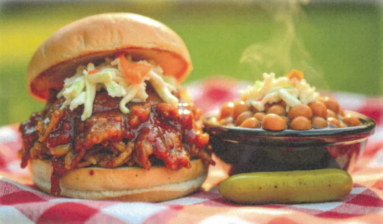 BBQ sandwich and bowel of baked beans with a pickle