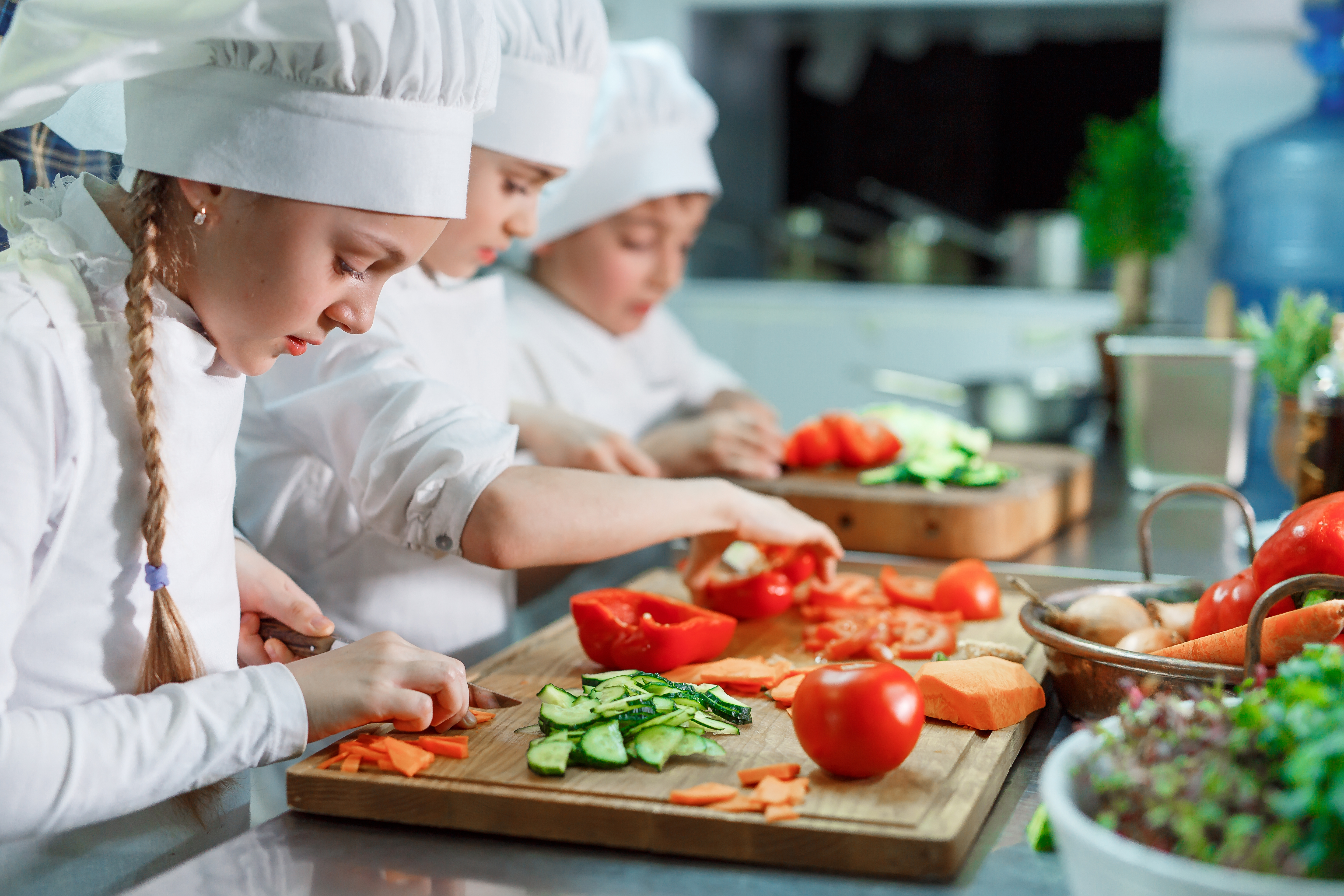 Children cutting vegetables