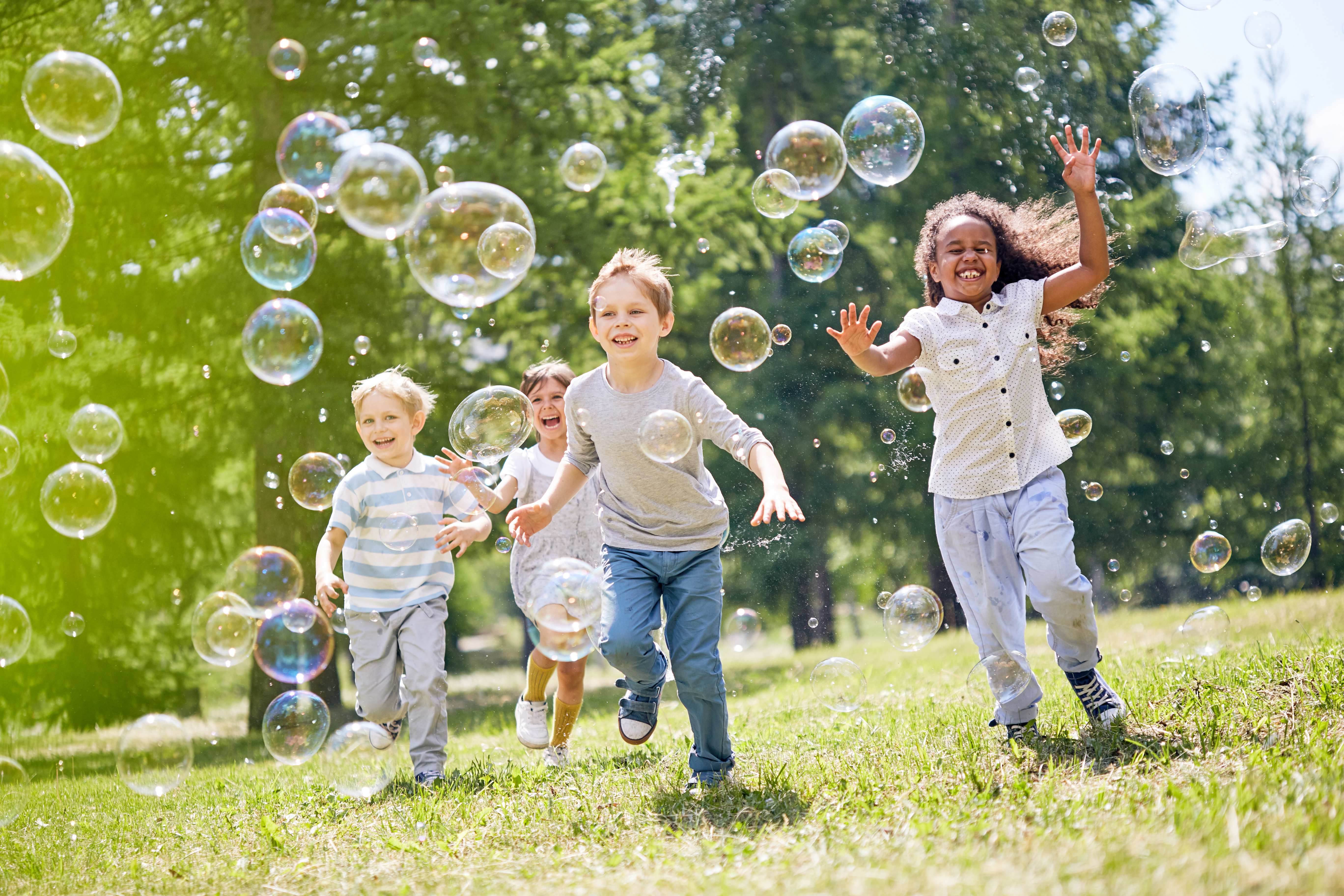 Children running with bubbles