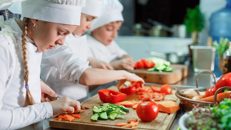 Children cutting vegetables